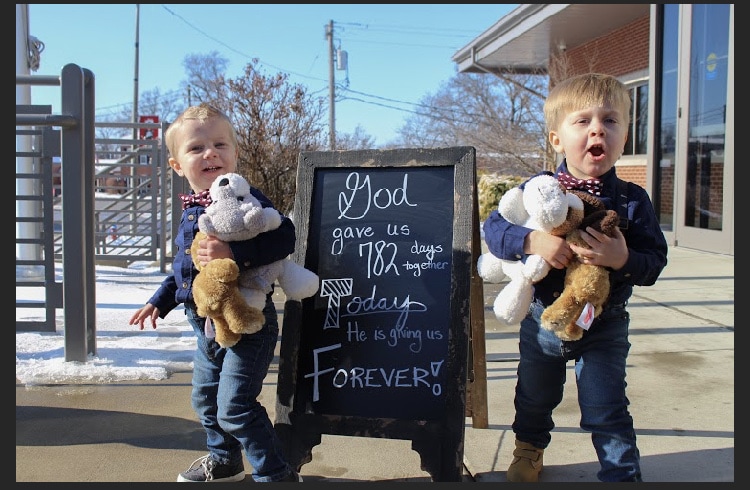 little foster boys happy holding toys